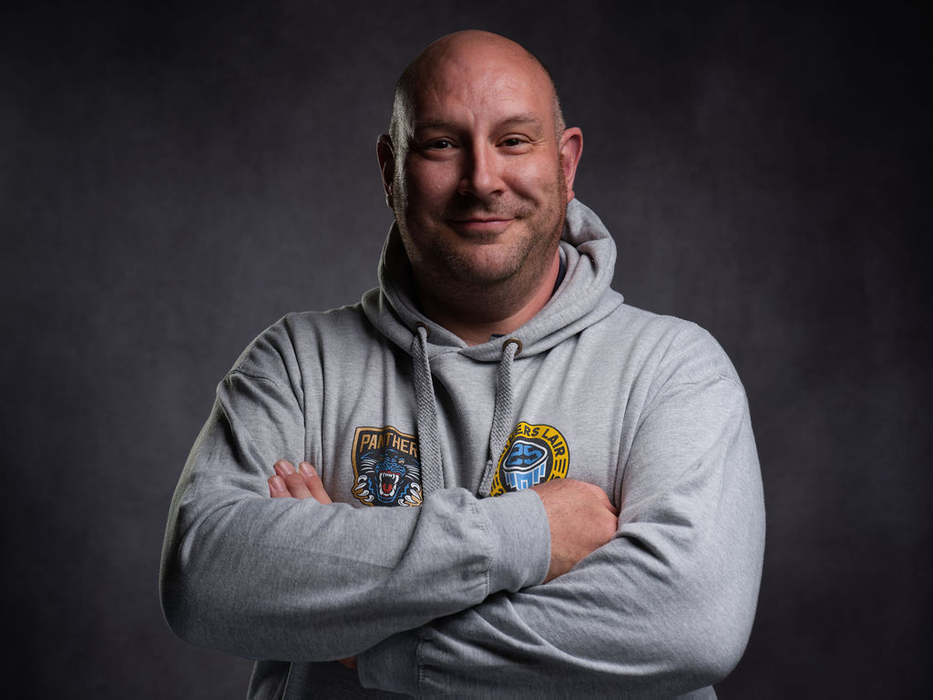 Dave - A friendly, happy and relaxed looking man with his arms crossed. His photo for meet the team at BD Boudoir